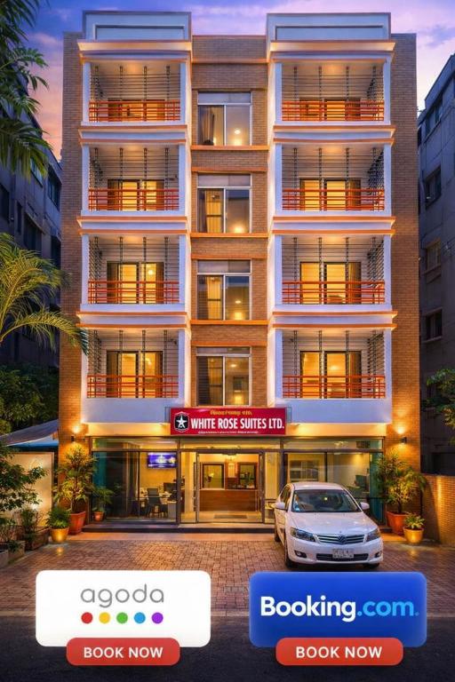 a building with a car parked in front of it at Baral White Rose Hotel Dhaka in Dhaka