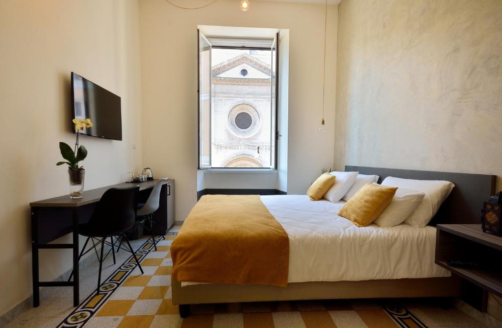 a bedroom with a bed and a desk and a window at Room with a view 105 in Rome