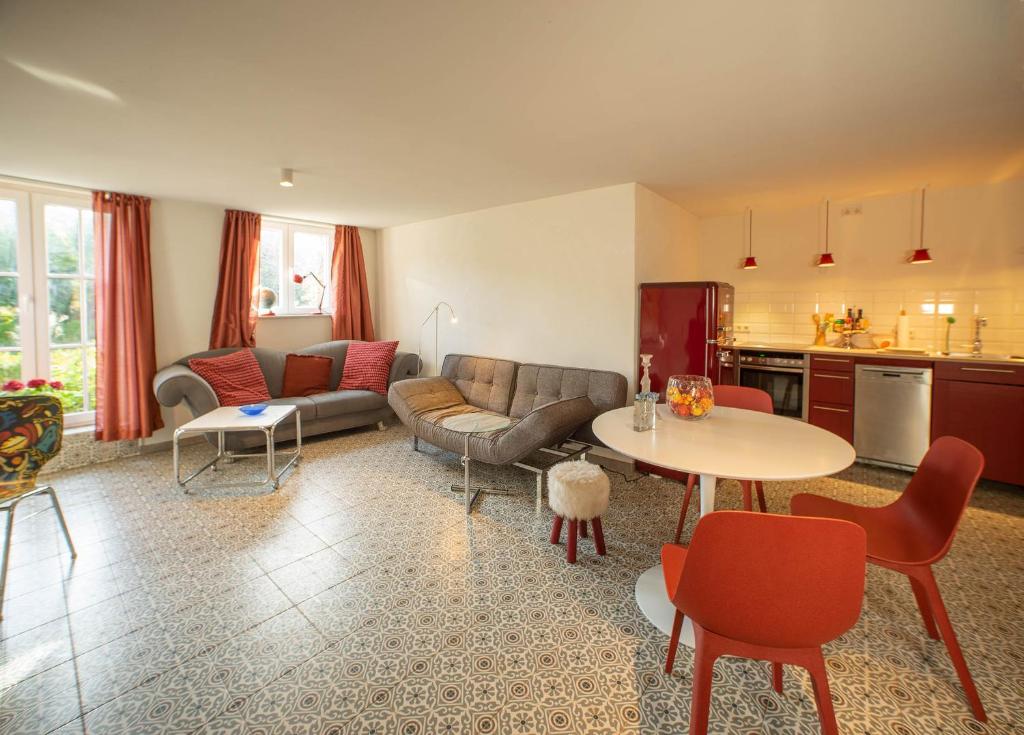 a living room with a couch and a table at Loft 4 in Schleiden