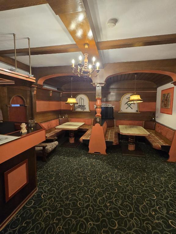 a train dining room with tables and a chandelier at Hotel Haus Kärnten in Bad Bleiberg