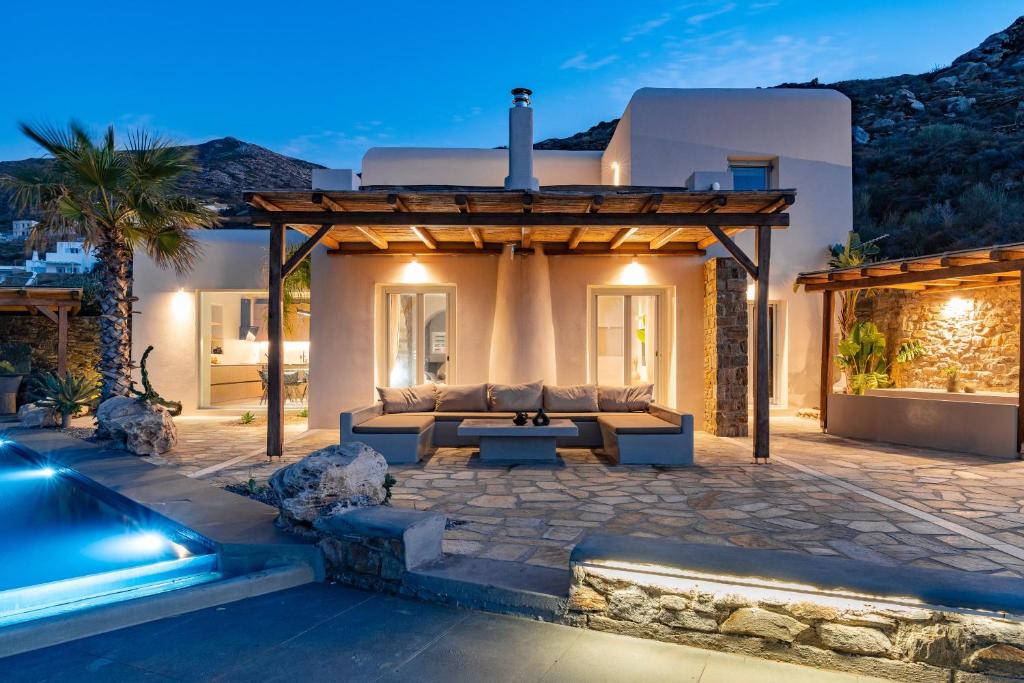 een villa met een patio en een zwembad bij Luxury Villa Delphinus - AllParos Villas in Paraspóri