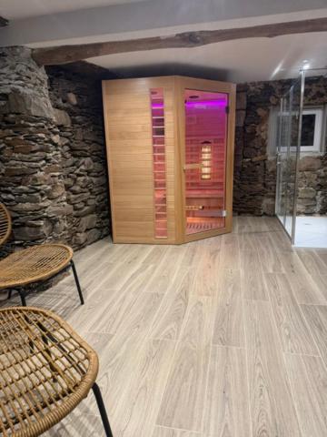 a room with a wooden door and a table and chairs at LevOasi 3 - Garden, jacuzzi and sauna escape in Levo