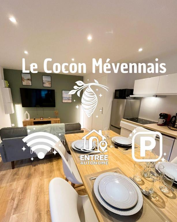 a kitchen with a table and chairs in a room at Le Cocon Mévennais in Saint-Méen-le-Grand