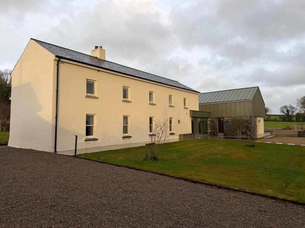 a large white house with a grass yard at Cluain Alainn in Cashel