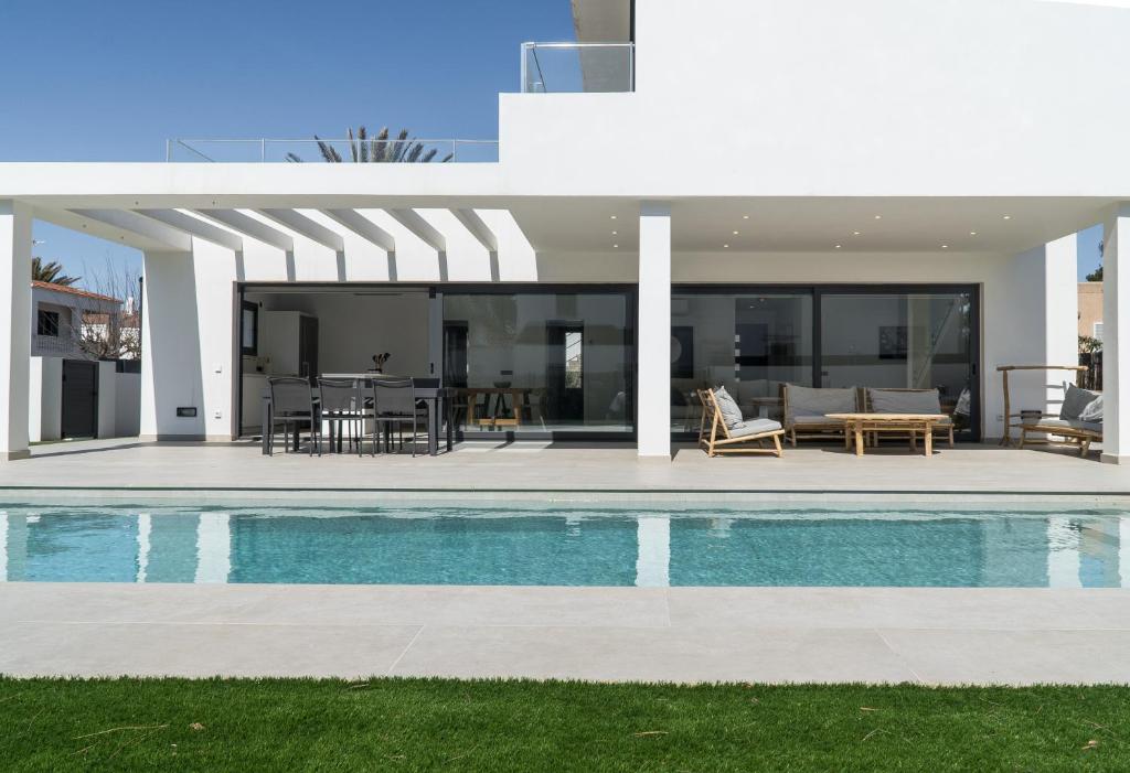 a villa with a swimming pool and a house at s'ANDRONA in Ciutadella