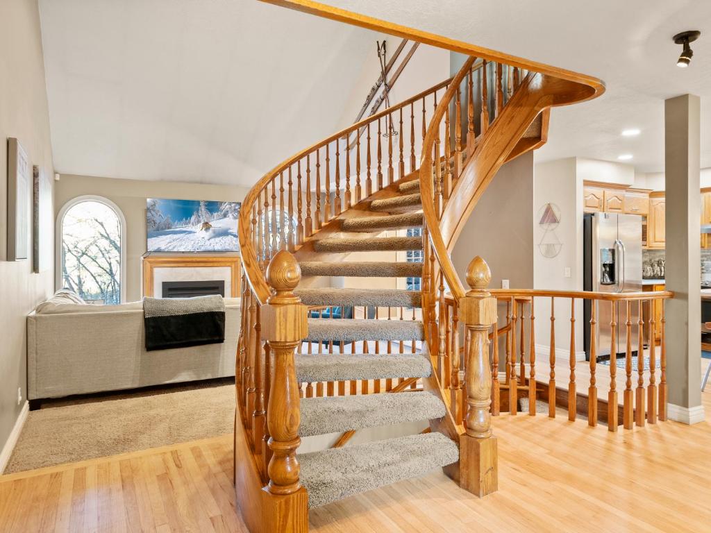 a wooden staircase in a home with a living room at Alpine Base Camp Hot Tub 1Gbps pool table foosball in Cottonwood Heights