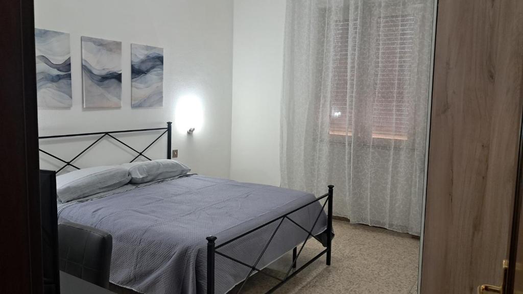 ein Schlafzimmer mit einem Bett und einem Fenster in der Unterkunft La casa del capitano in Tarquinia