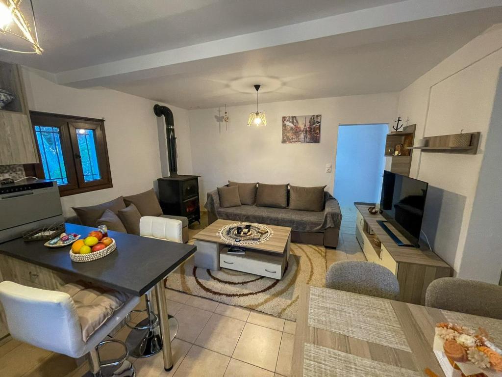 a living room with a couch and a table at Elpida's Retreat, Pelion in Tsagarada