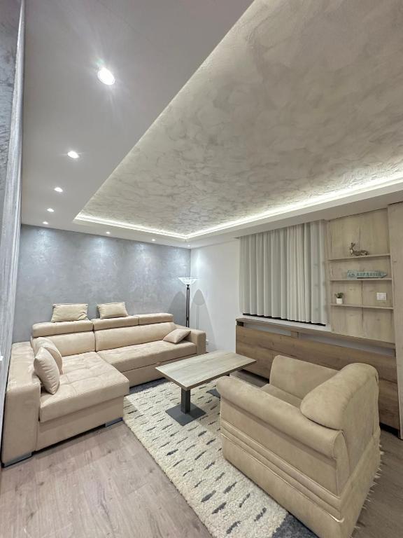 a living room with couches and a table at MB Apartmani Kopaonik in Kopaonik