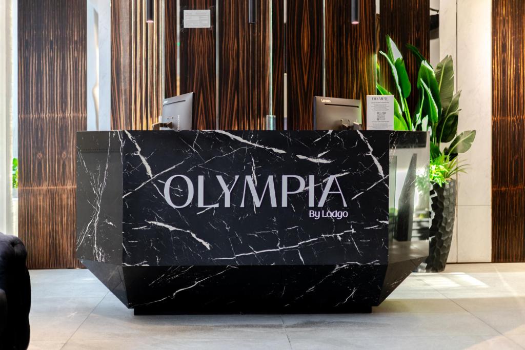a black marble reception desk in a lobby at Olympia Hotel by Lodgo in Montreal