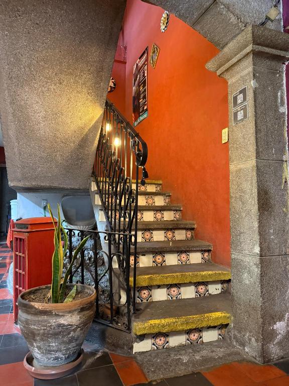 a staircase in a building with people on it at Cristales de Antigua Hotel Cristal in Antigua Guatemala