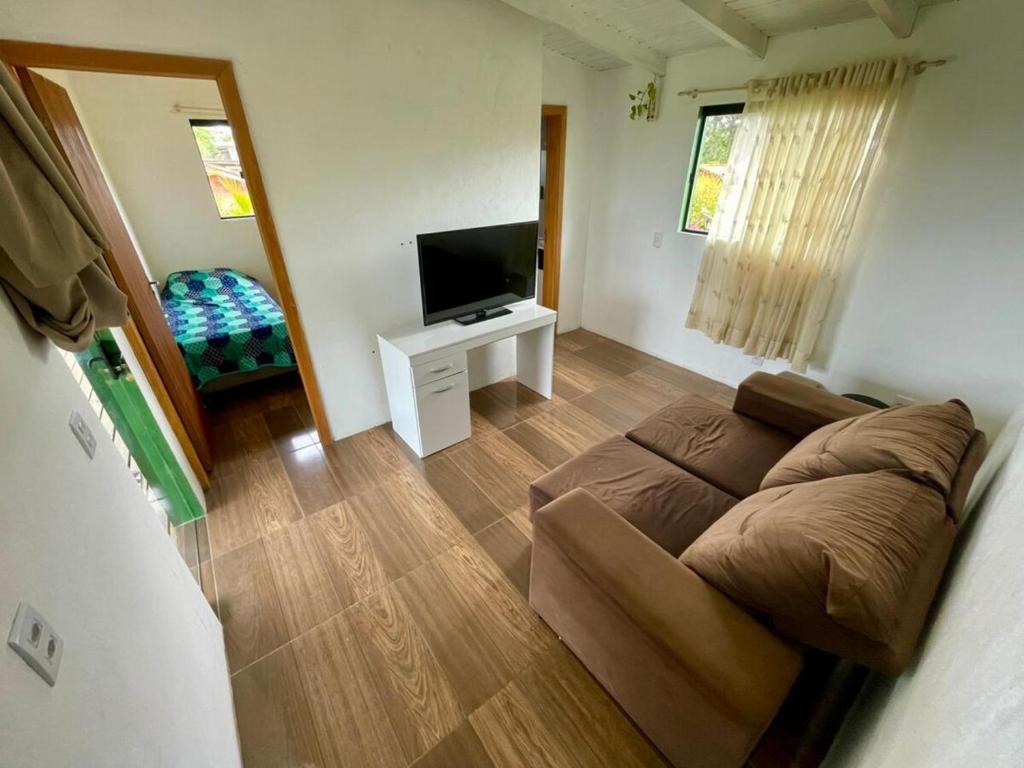 Et tv og/eller underholdning på Apartamento 2 Dormitórios Praia do Rosa