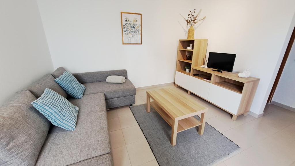 un soggiorno con un divano e una TV di Cosy Vau a Vau