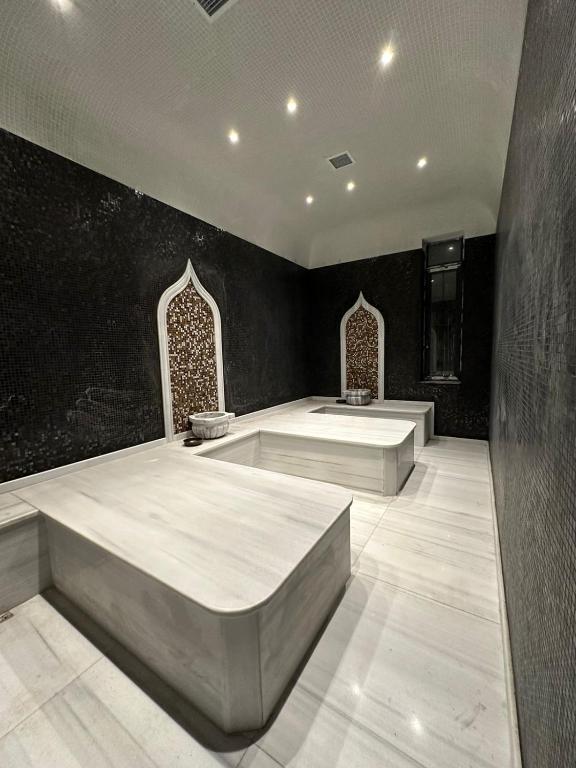 a large room with two large beds in it at LIFESPORT-Complex Hotel & spa in Əlǝt