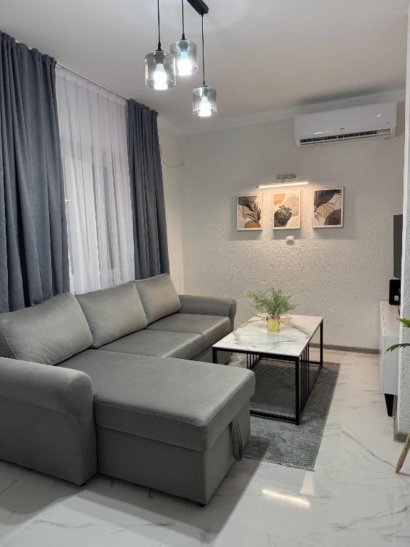 a living room with a couch and a table at Comfort House Kocani in Kočani