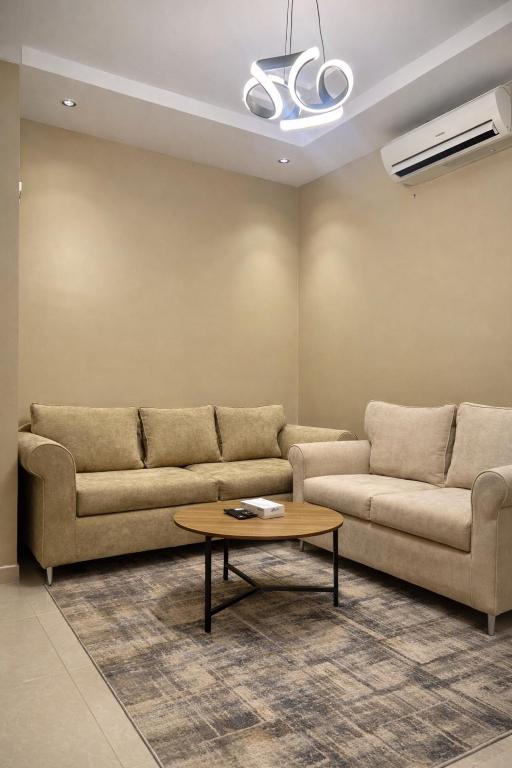 a living room with two couches and a coffee table at سويت غرفتين وصالة مميز in Jeddah