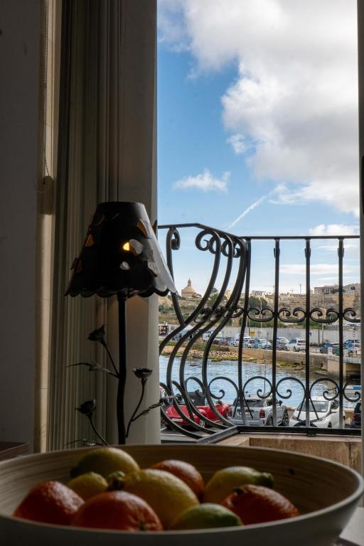 a bowl of fruit in front of a window at Silver Harbour - 2 Bedrooms, 2 Bathrooms in Il-Gżira