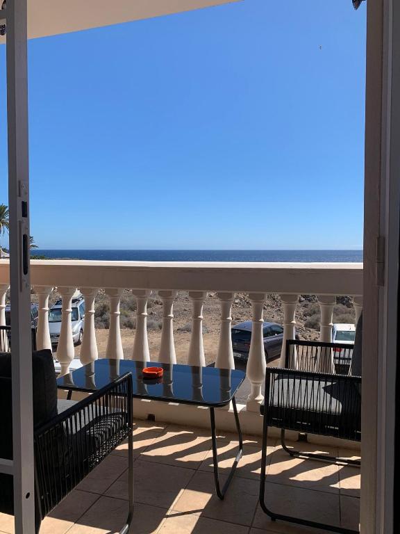 a balcony with chairs and a view of the ocean at 4 seasons relax apartment in Costa Del Silencio