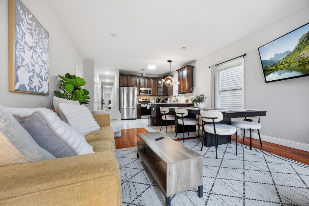 a living room with a couch and a table at 3 BR • Full Kitchen • Sleeps 8 in Jersey City