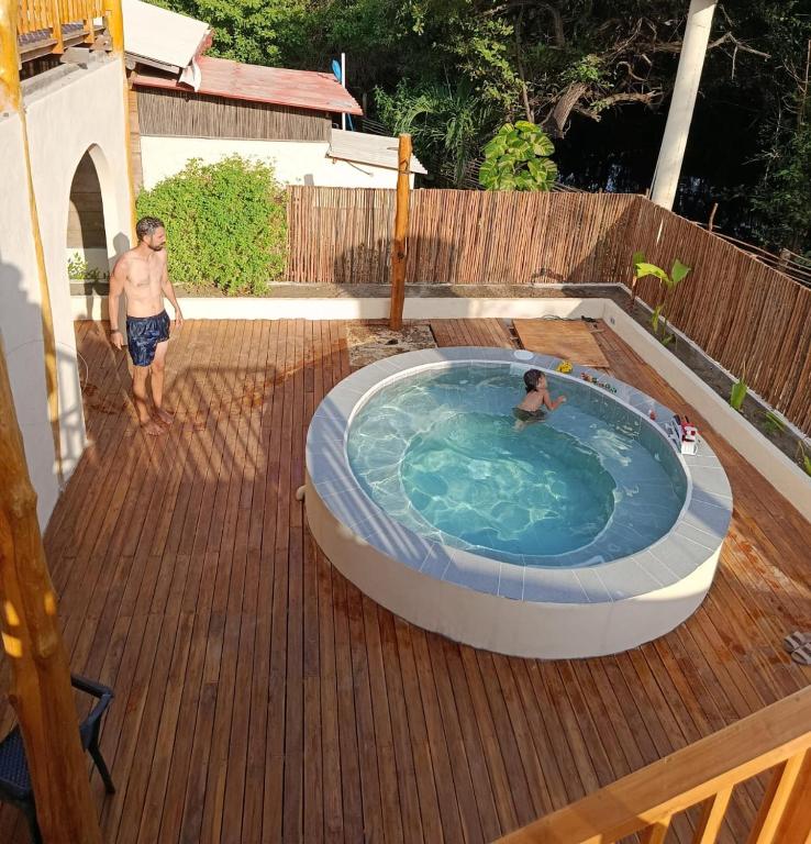 two men standing in a hot tub on a deck at Paraíso Natural Ecohotel in San Bernardo del Viento