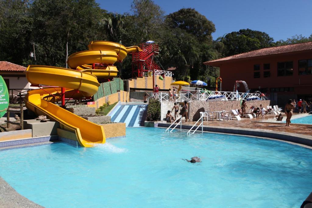 a person swimming in a pool in a water park at Hotel Mato Grosso Águas Quentes in Sucuri