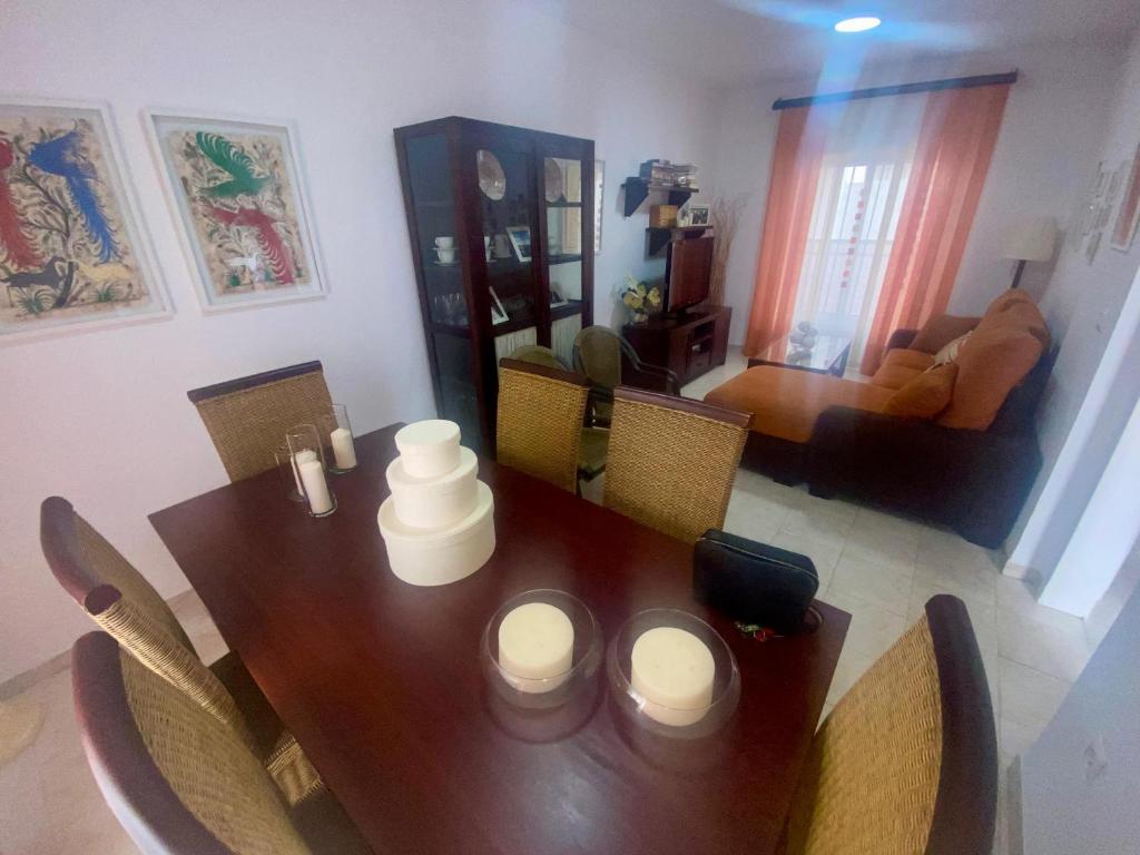 a wooden table with chairs and a dining room at Casa 3 min andando playa AC WiFi 8 pax Doñana in Matalascañas