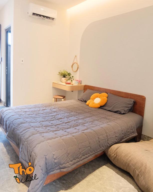 a bedroom with a bed with a teddy bear on it at Thỏ Chill Homestay in Vung Tau