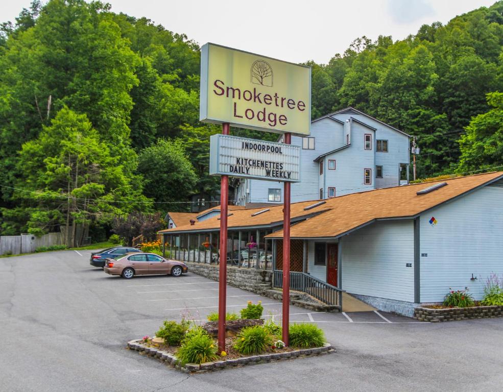 a sign for a smokehouse lodge in a parking lot at Smoketree Lodge, a VRI resort in Banner Elk