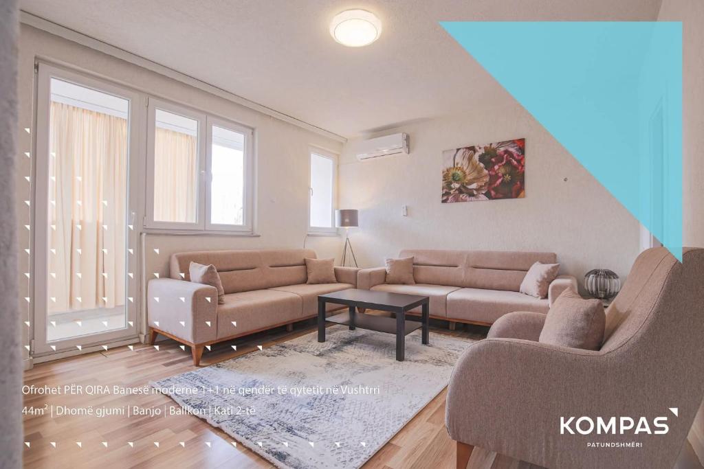 a living room with two couches and a table at Nice apartment at the center of Vushtrri city in Mitrovicë