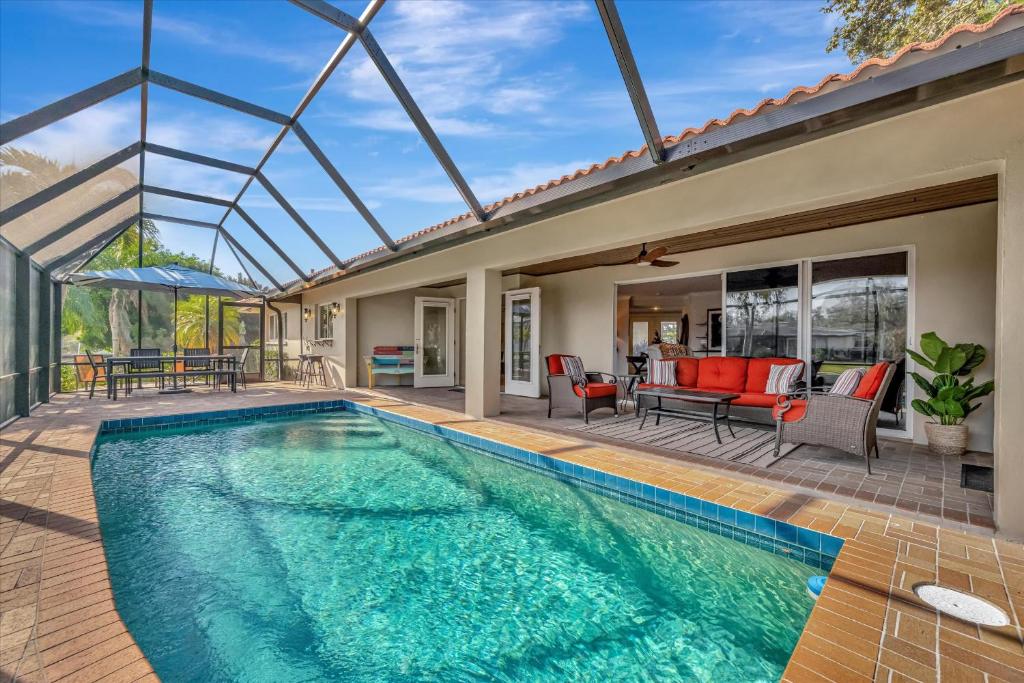 a swimming pool in a house with a glass ceiling at Siesta Key Beach Waterfront Home with Kayaks and Bikes in Siesta Key