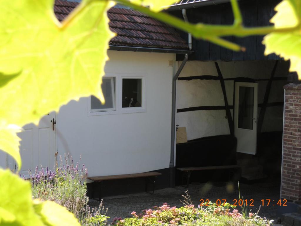 a white house with a window and a door at Vakantie appartement Paedshof Ransdaal in Ransdaal