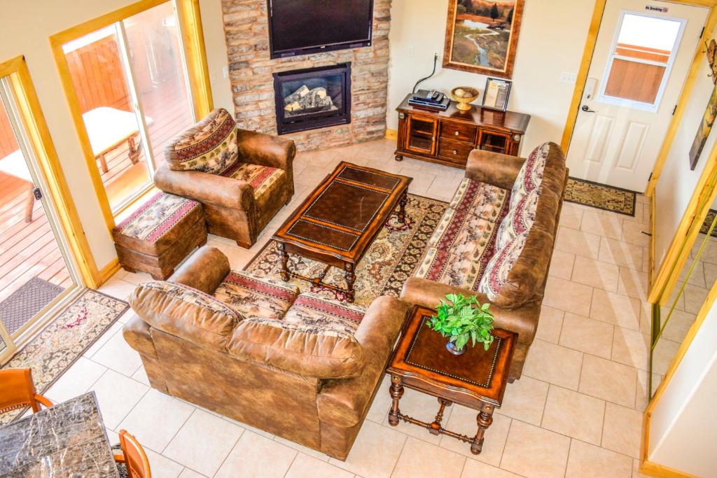 a living room with leather furniture and a fireplace at The Lodge at Duck Creek in Duck Creek Village