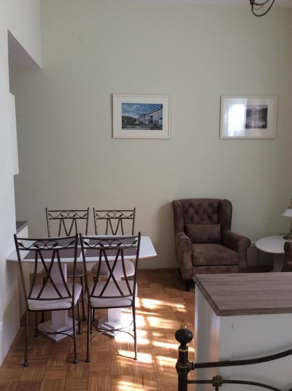 a living room with a table and chairs and a couch at Vila Rogaška in Rogaška Slatina