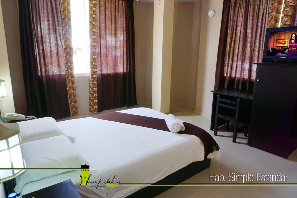 Postel nebo postele na pokoji v ubytování Hotel Wampushkar