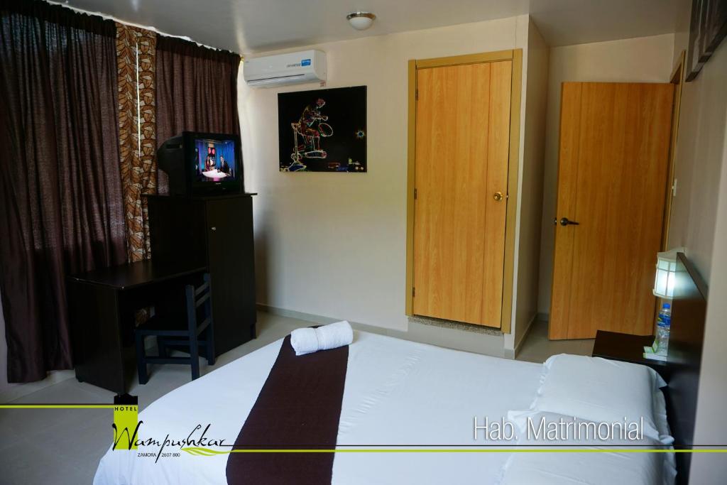 Postel nebo postele na pokoji v ubytování Hotel Wampushkar