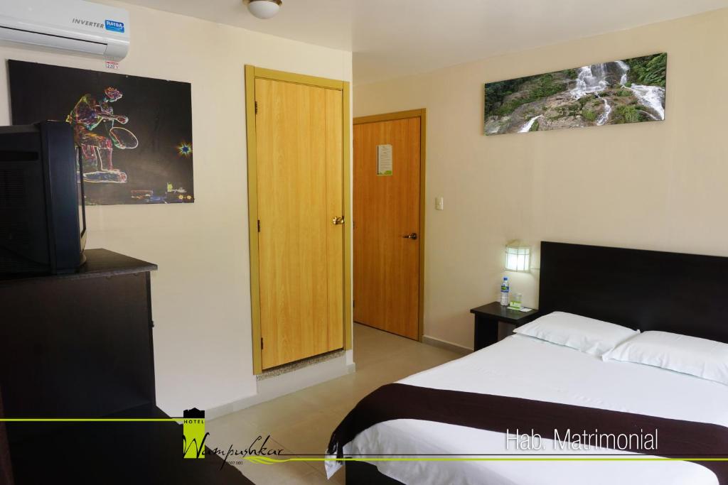 Postel nebo postele na pokoji v ubytování Hotel Wampushkar