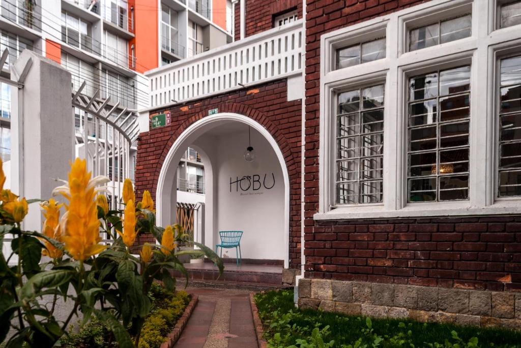 a brick building with an archway in front of it at Hobu Hostel in Bogotá