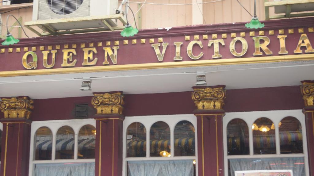 a store front with a sign that reads queen victoria at Queen Victoria Inn in Pattaya Central