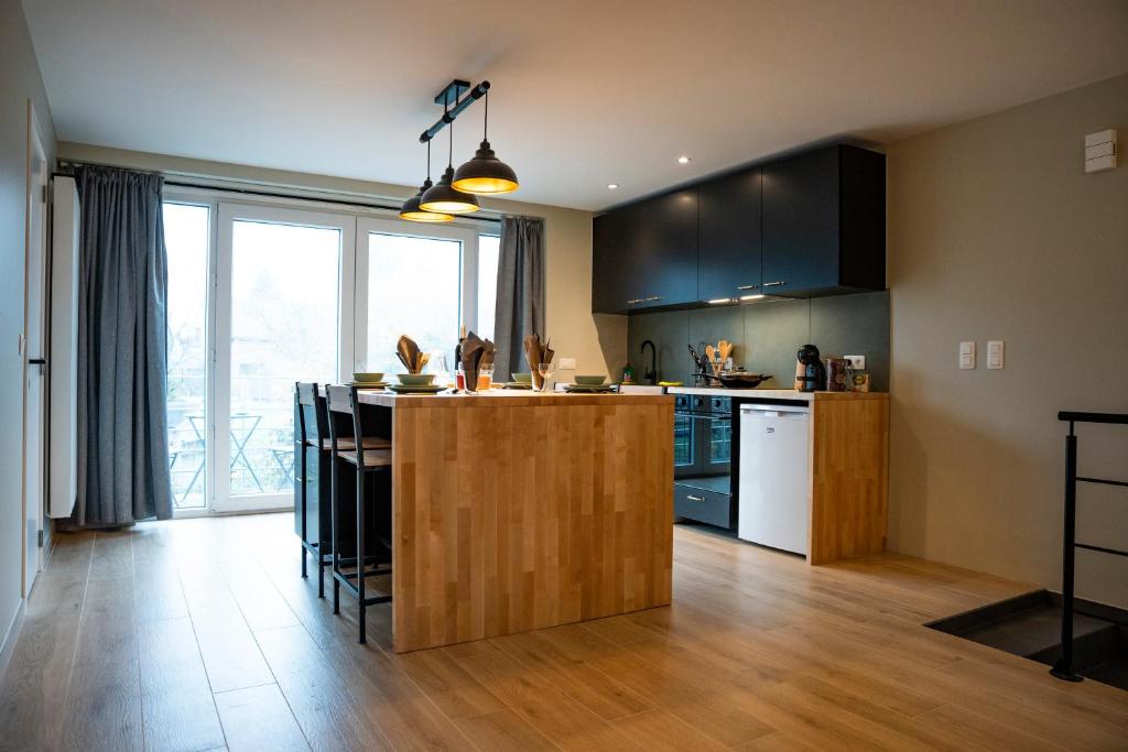 a kitchen with a island in the middle of a room at Apartment - 3 guests in Mont-Saint-Guibert