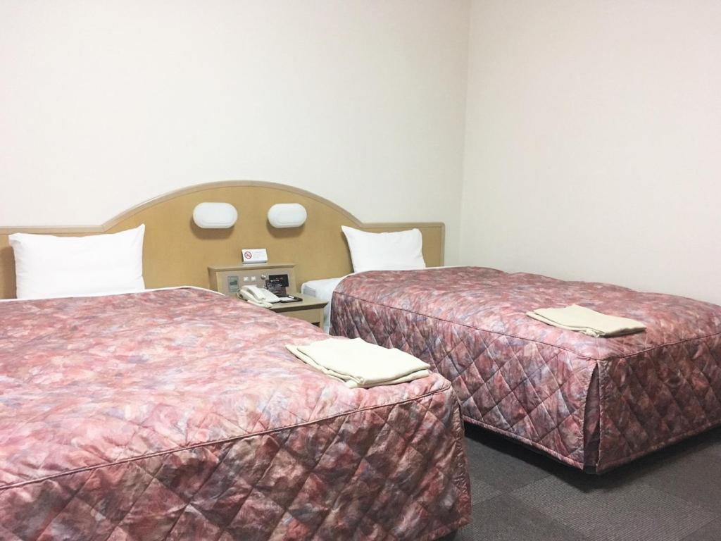 Postel nebo postele na pokoji v ubytování Oustat Kokusai Hotel Tajimi