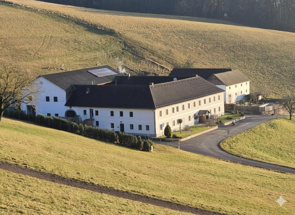 an aerial view of a large white building in a field at Wohnung im Herzen Mühlviertels in Bad Zell
