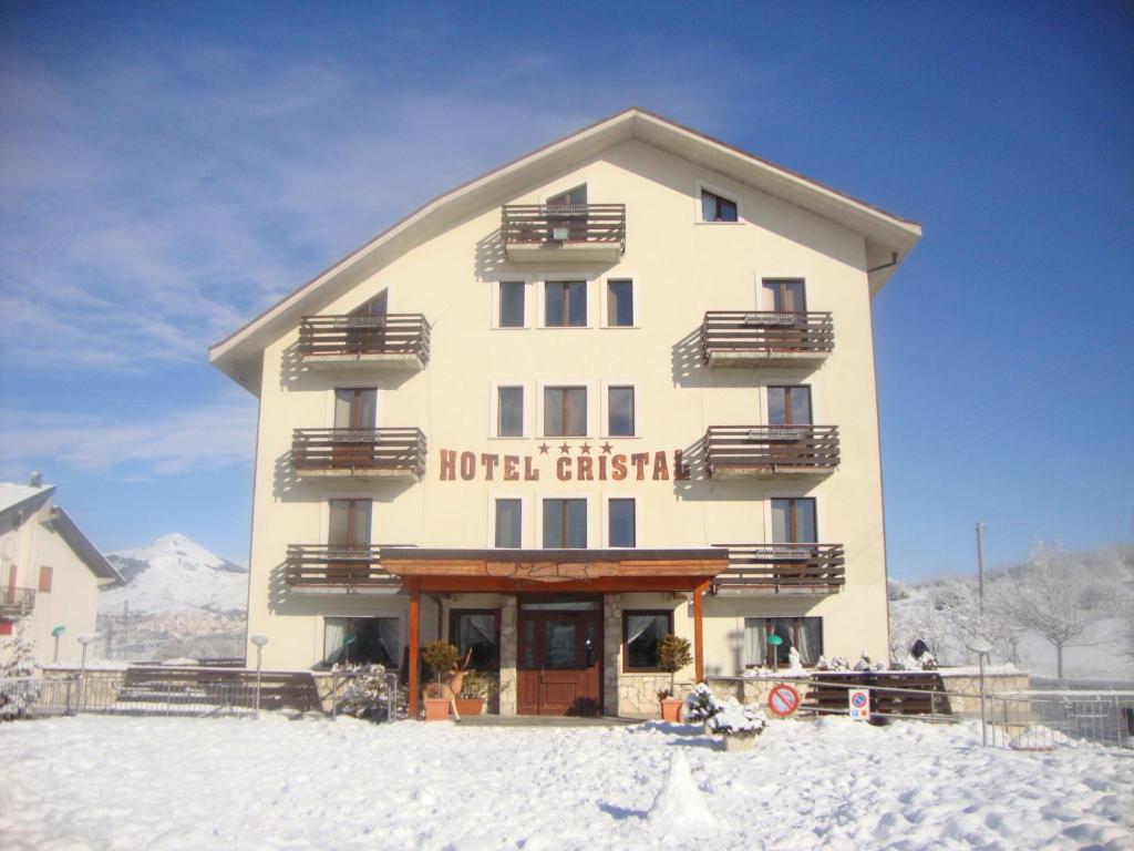 a hotel in the snow in front of a building at Hotel Cristal in Roccaraso