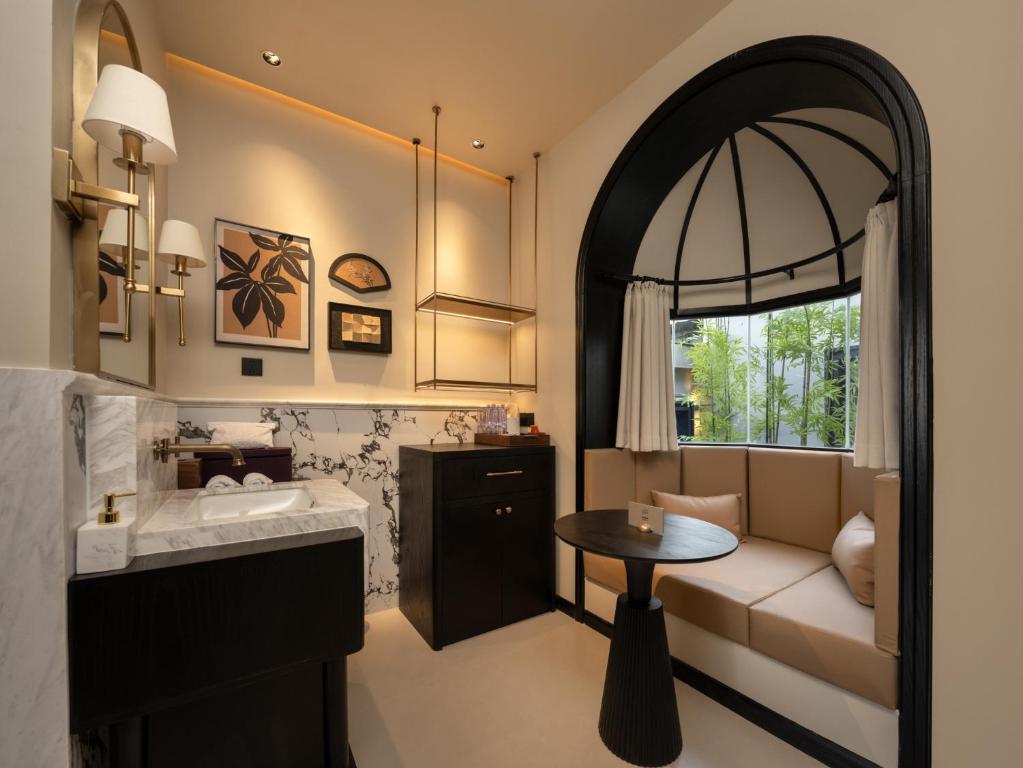 een badkamer met een wastafel en een tafel bij 龄舍1927酒店 in Wuhan