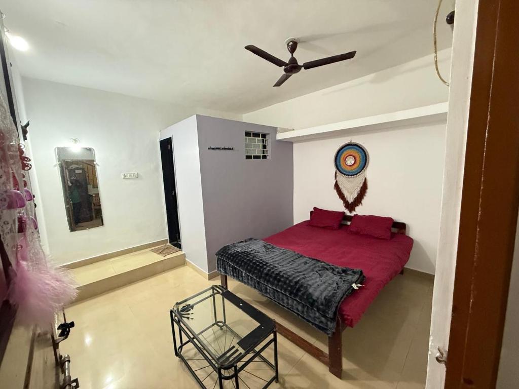 a bedroom with a bed and a ceiling fan at Trippy Turtle in Arambol