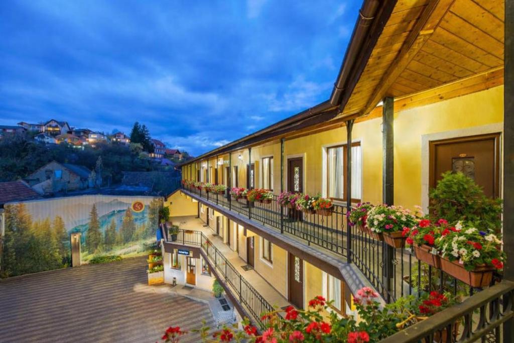 a view of a building with flowers on balconies at Long Street Hotel in Braşov