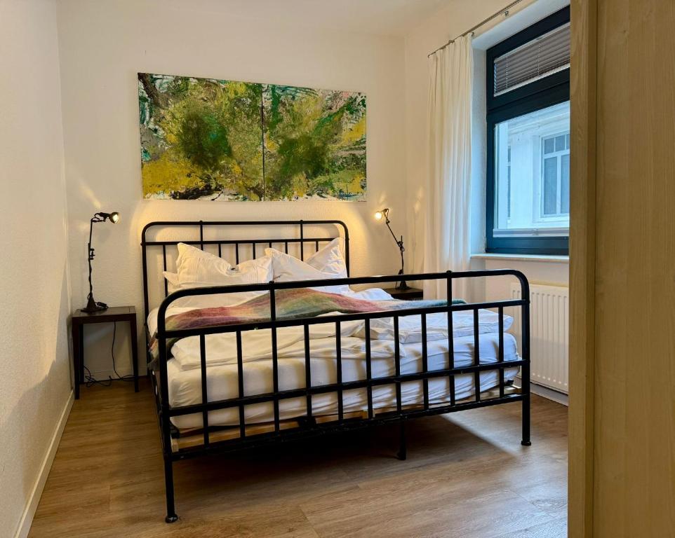 a bedroom with a bed and a painting on the wall at Fewo KLÜN's 1 in Jever