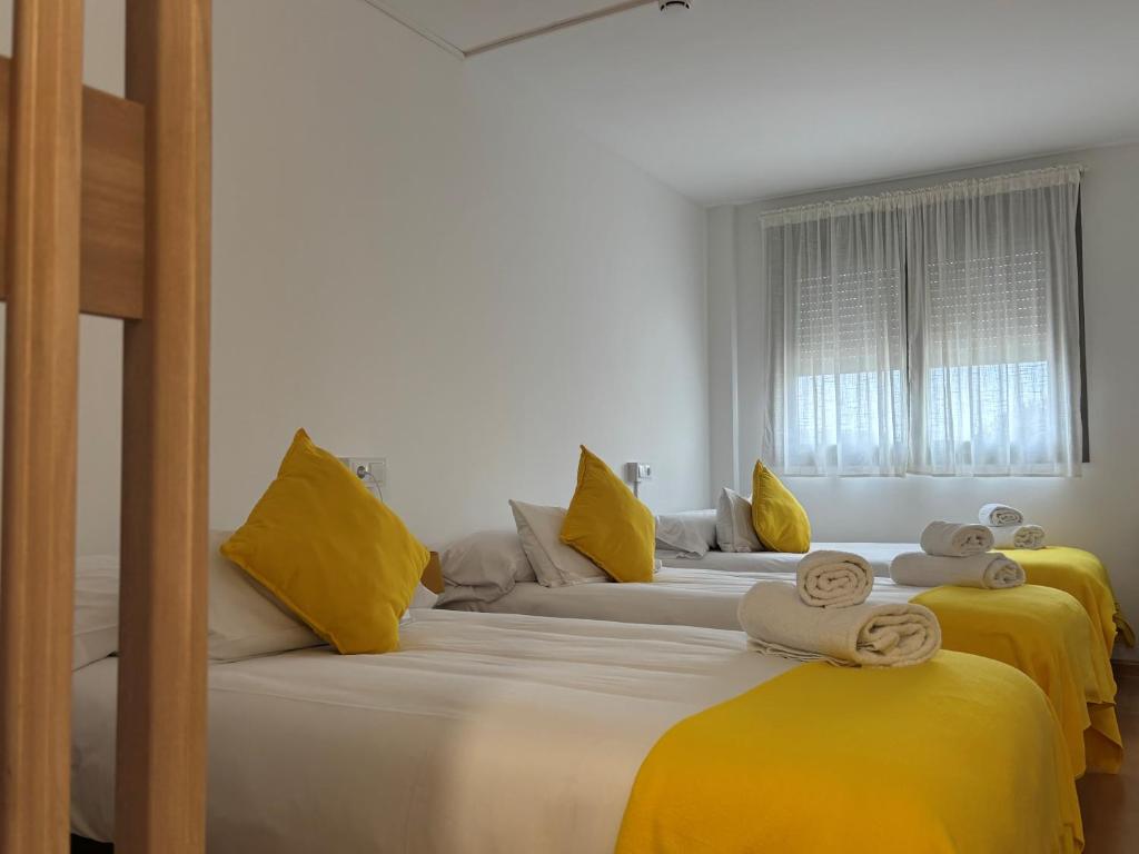 En eller flere senge i et værelse på Hostal Batallar