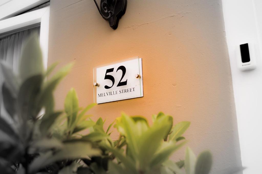 a sign on a wall with the number on it at The Bell Lodge in Sandown