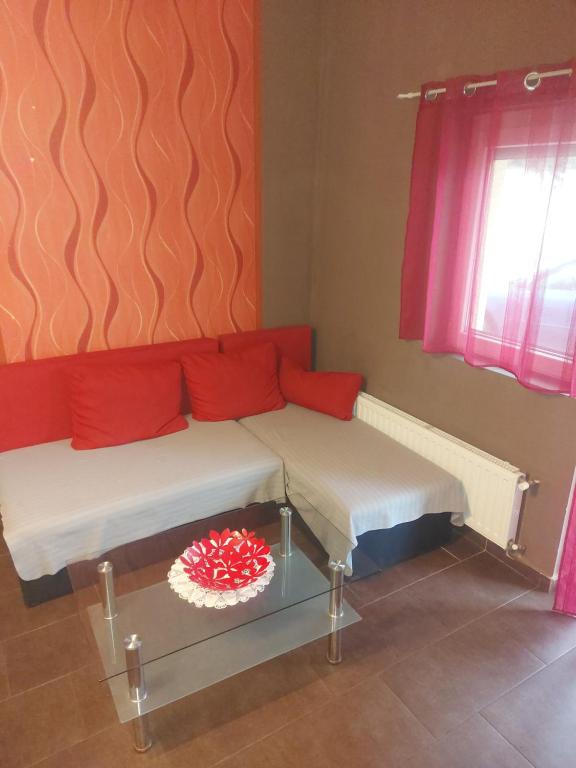 a living room with a couch and a table at Siófok 7 Apartmanház in Siófok