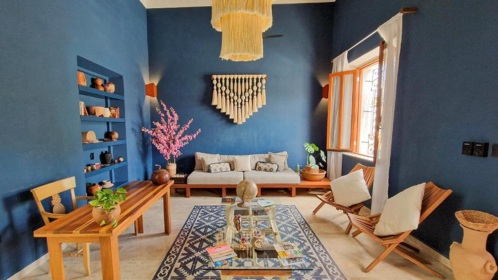 a living room with a couch and a table at Casa María Eulalio - Boutique Guesthouse in Mérida